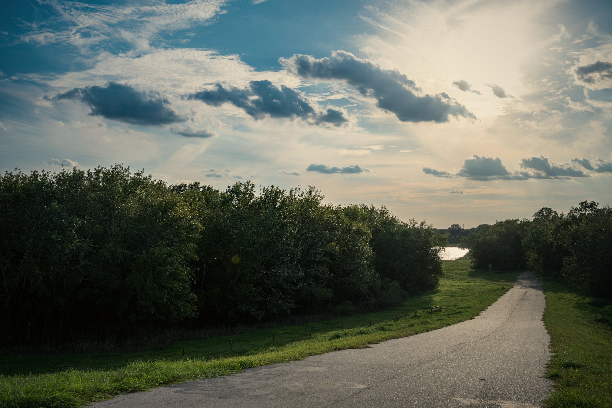 A country road under a cloudy sky