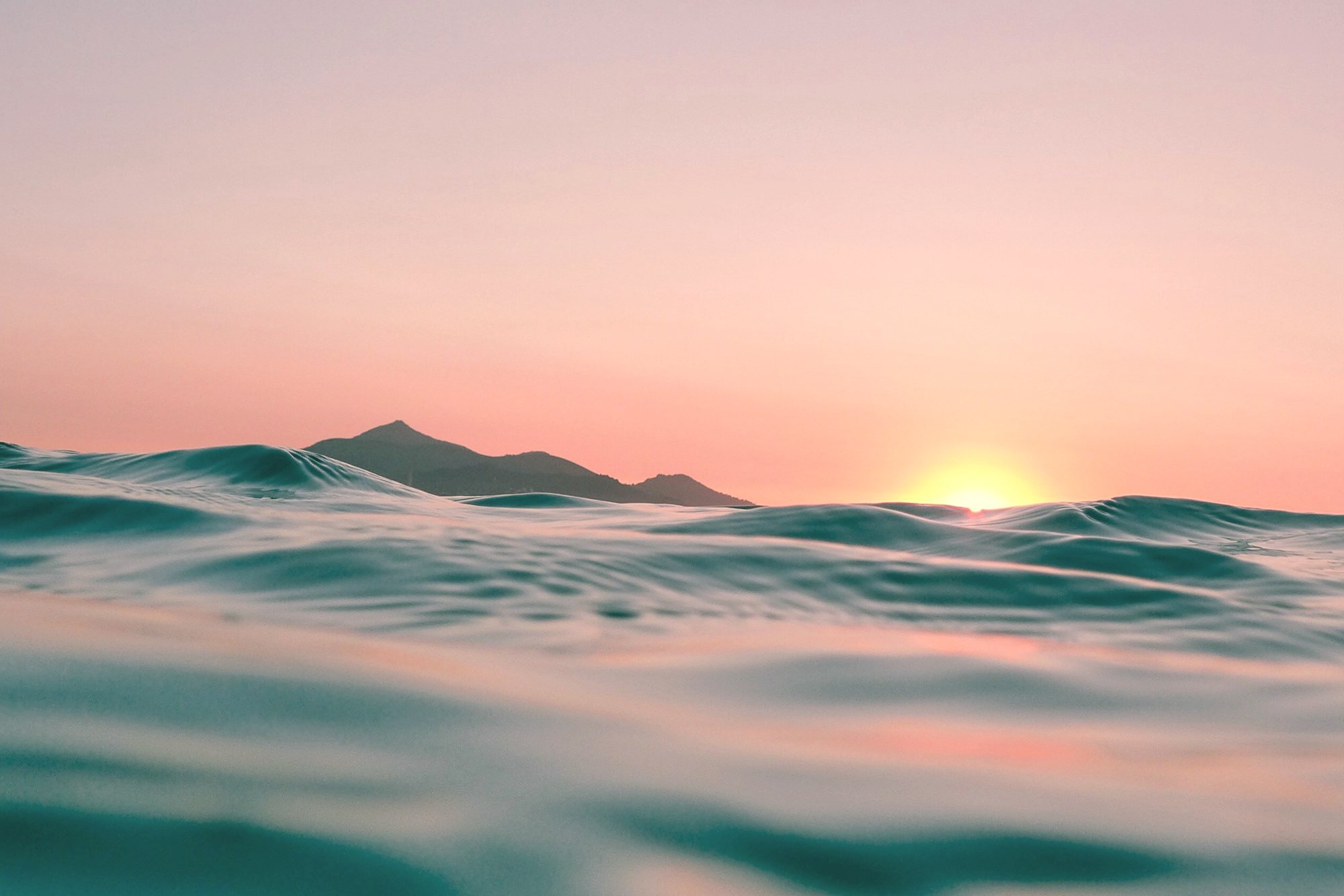 Ocean water at sunset, seen from the surface